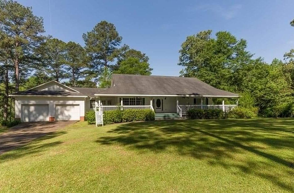 Beautiful home nestled on an oversized lot that borders a slew of Lake Tuscaloosa.