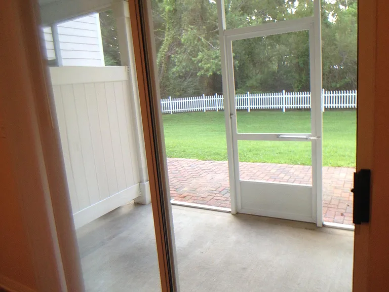 This townhome unit has a screened in porch and a cobble stone patio.
This is a view from the Livingroom.