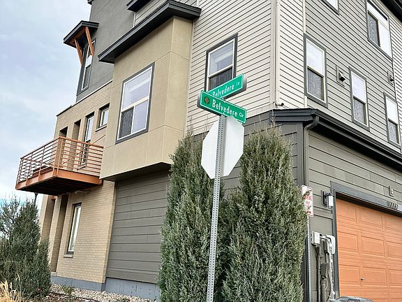 Modern, airy, and solar-powered end-unit townhouse with a large deck wrapping the northwest corner.