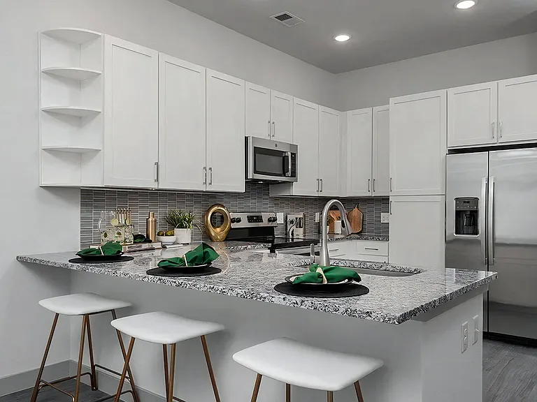 Open Kitchen Layout with White Cabinets and Stainless Steel Appliances