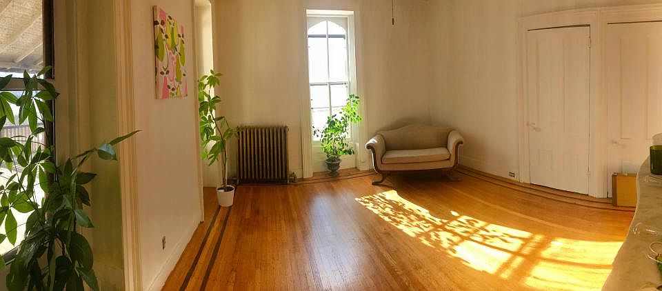 Light pouring through living room with walkout access to pri
