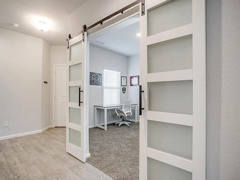 Private study with modern barn doors.