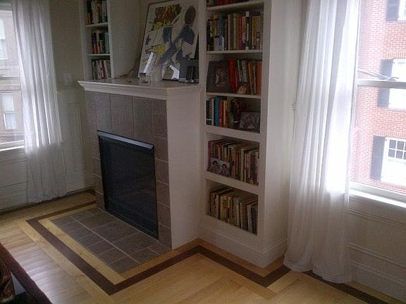 Built-ins surround gas fireplace in living/dining area