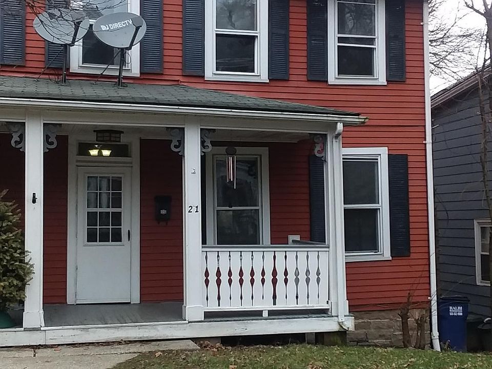 Inviting front porch, lighting, screen door for breezy days.