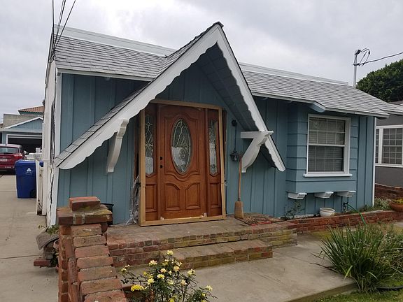 Work-in-progress shows new roof and exterior paint, with new stained glass door being installed.