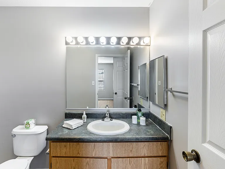 Large bathroom with illuminated makeup vanity