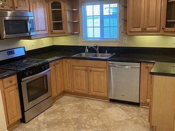 Kitchen with stainless steel appliances, recessed lighting,