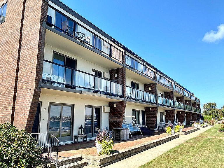 Back side of condo facing East and Newport Harbor. Second floor, covered deck with railing