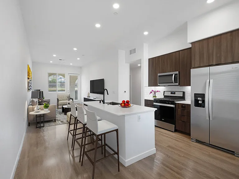 Cook and entertain in a kitchen featuring stainless steel appliances and a spacious island with seating for all.