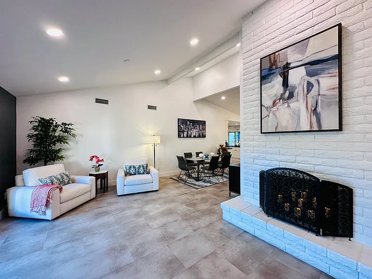 Two-Way Fireplace: 
A striking architectural feature that anchors the living spaces and adds a warm ambiance.