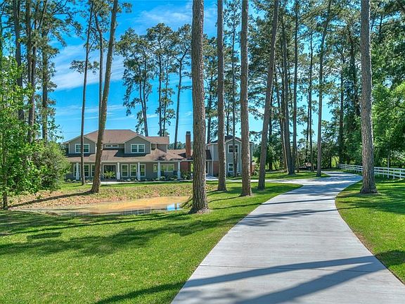 Drive up through the mature trees into a dream! Circular reinforced concrete driveway is brand new and takes you through the porte cochere and around the garage apartment.