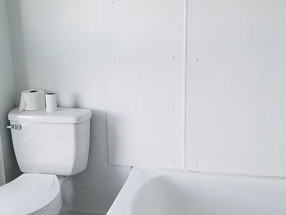 Spacious light filled bathroom, with fresh paint