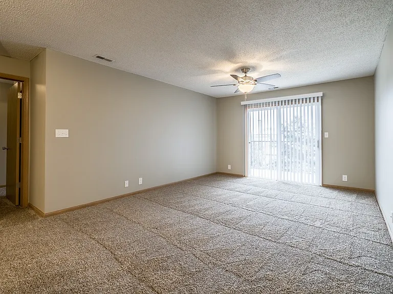 Kick back in your spacious living room featuring plush carpet, fresh paint, and seamless flow into the kitchen and dining spaceperfect for everyday living.