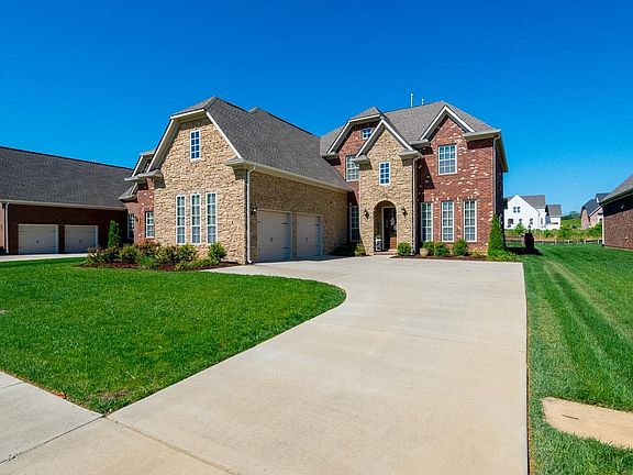 Another view of the beautifully landscaped home - sprinkler system in front