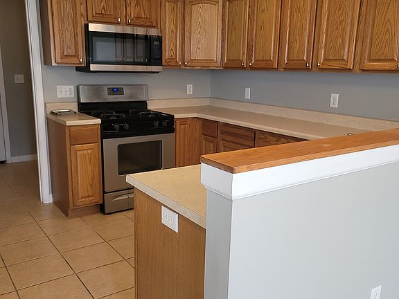 Kitchen full view of cabinetry Kitchen also has large cabinets in a pass through to the living room.