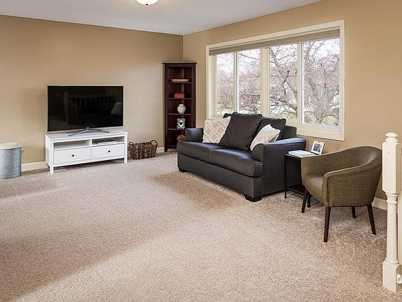 The main level living room has new carpet and great big window providing nice natural light!