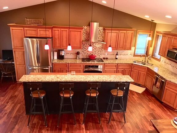 Like to cook?  Check out this totally remodeled kitchen. Aracia hardwood floors, butcher block center island, granite counters, loads of new cabinets, tile backsplash, wine credenza, stainless appliances.