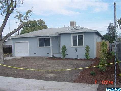 street view--newly seeded front yard with plants & automatic sprinklers
