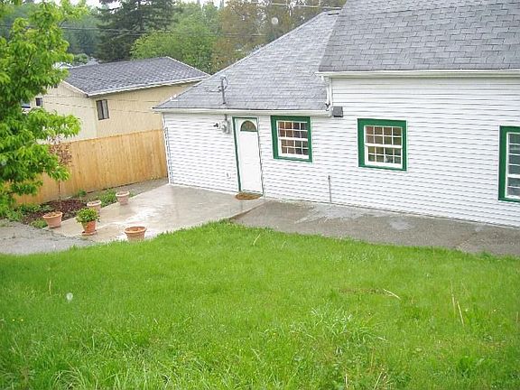 Back of the house/back door side from far corner in backyard