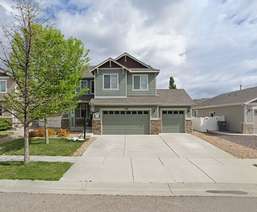 Front of home with three-car garage and huge driveway