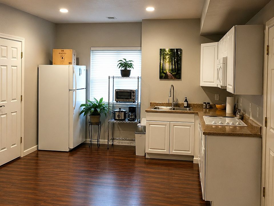 Full kitchen including 4-burner instant on electric cooktop and electric oven.