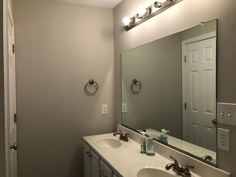 Large master bath with double vanity, deep soaking tub, shower, and toilet in separate space with door