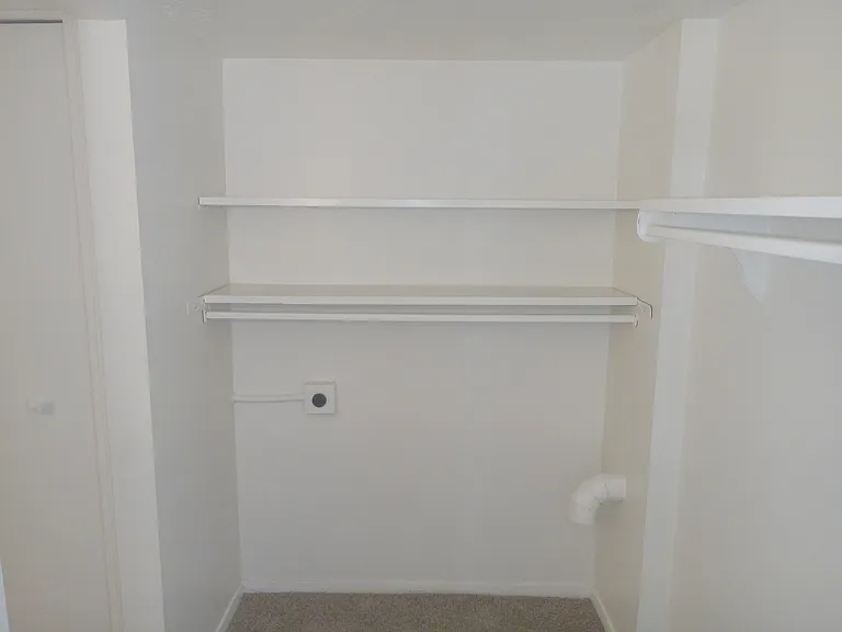 Walk in closet off larger bedroom
