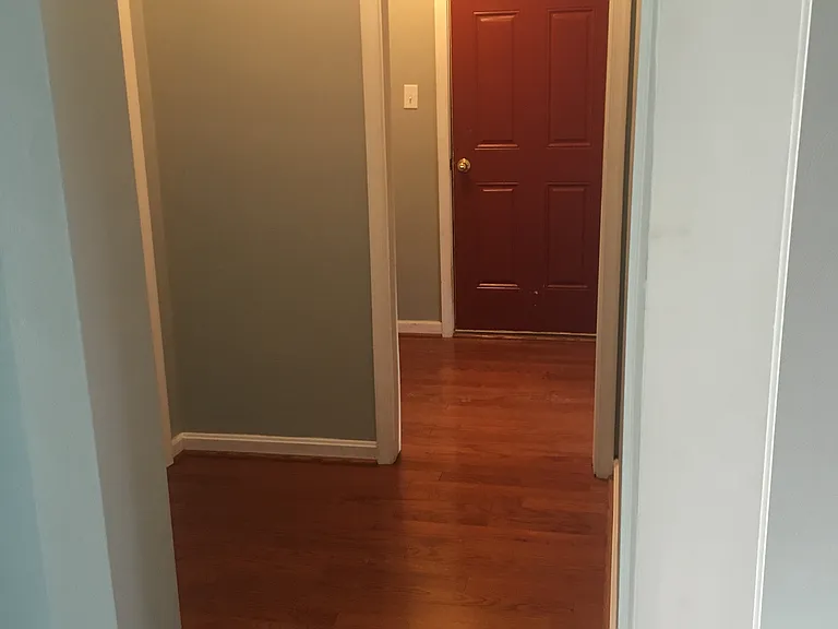 Hallway to laundry hookup and garage door.