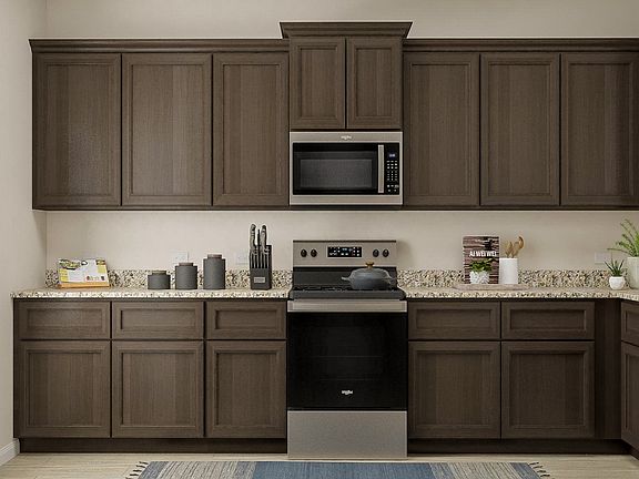 This kitchen includes a full suite of stainless appliances by Whirlpool.