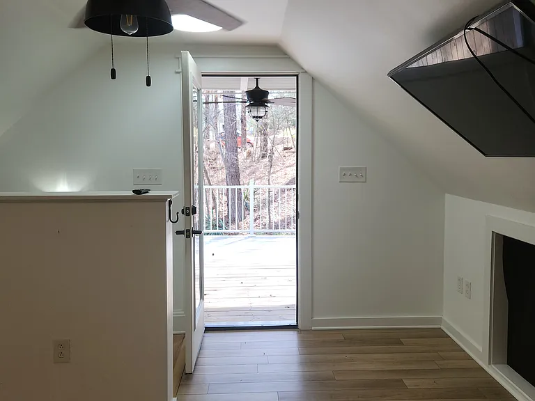 LOOKING OUT TO THE 2ND FLOOR PORCH FROM THE BEDROOM