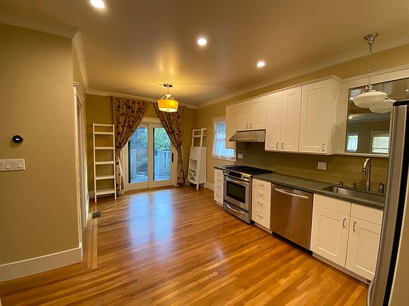 Kitchen and dining area with view to back porch and garden