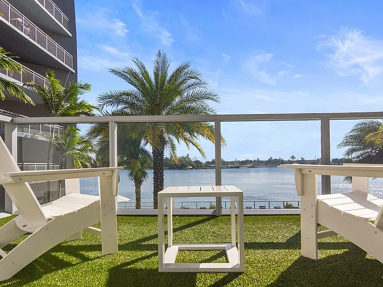 The outdoor deck invites you to relax in style with a backdrop of shimmering pool views