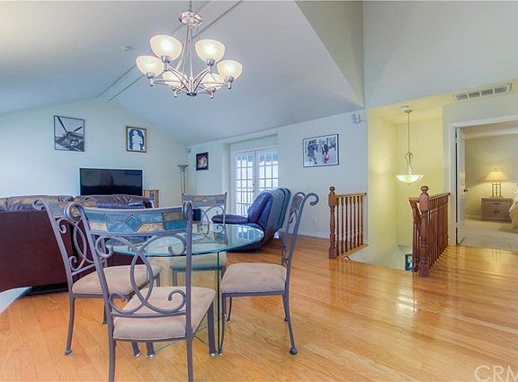 Dining area in great room.  French doors lead to good sized balcony.  Master upstairs bedroom in background