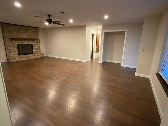 Another view of large living area and entryway nook from the formal dining room