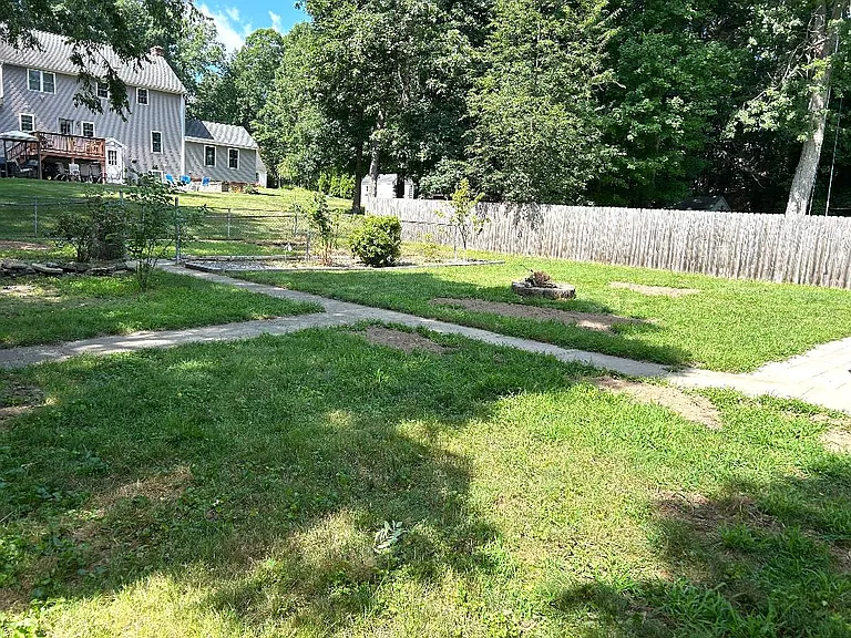 Back yard of 909 Lancaster St. with fire pit.