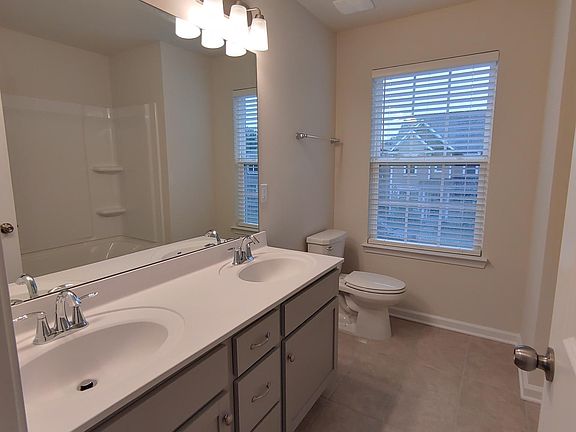 Hallway bathroom with double sinks