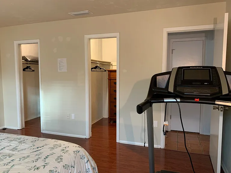 Two walk-in closets and a treadmill in the master bedroom.