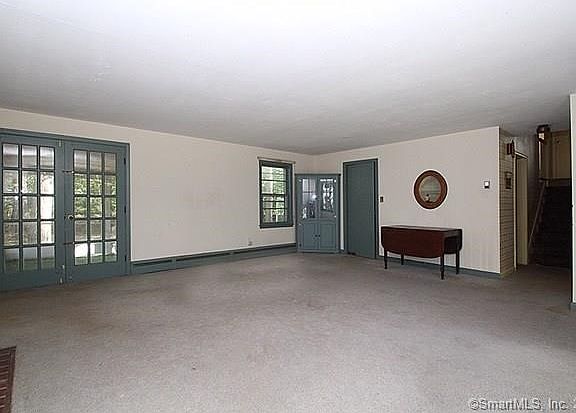 Living room view looking toward the back of the house. French-doors at the left lead to the screen porch.