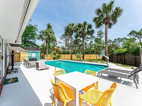 Enormous heated pool, outdoor shower, and fenced-in backyard.