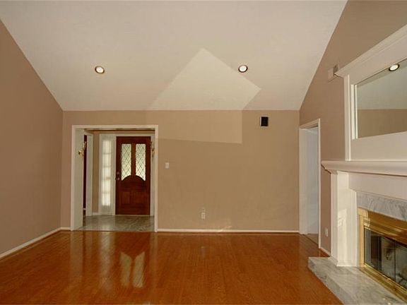 Soaring ceilings and gleaming wood floors accent this spacious living space.
