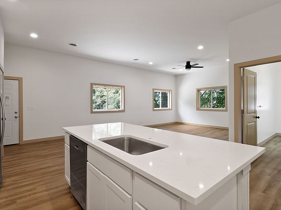View from the kitchen into the living/entry space. Kitchen faucet being installed.