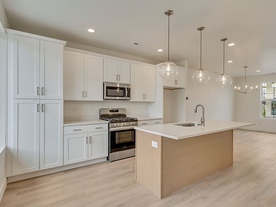 Kitchen with white cabinets and center island in a sego home