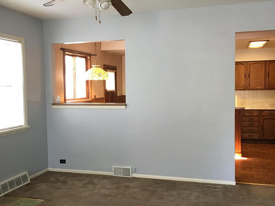 Dinning room with a pass through window into kitchen.