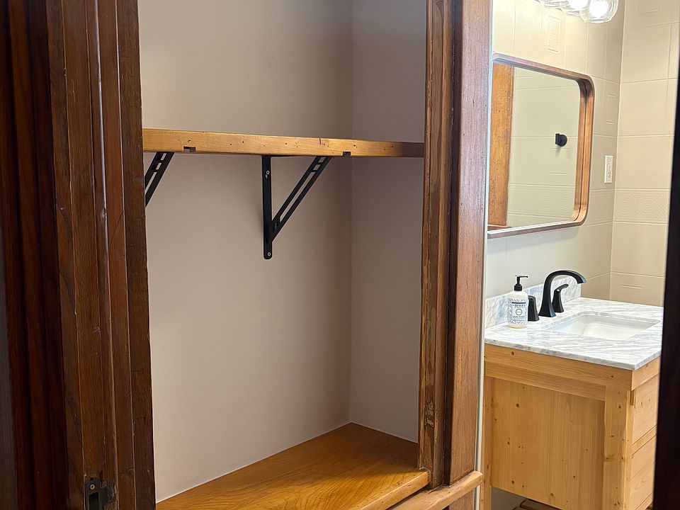 Updated bathroom with new vanity and refinished inset cabinetry.
