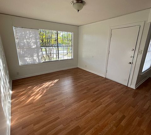 Large open living/dining area with natural light from windows.