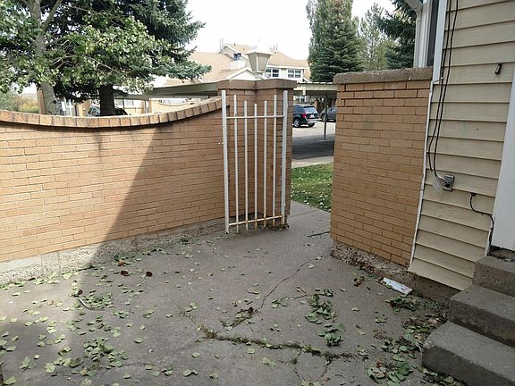 Gate to brick wall around porch