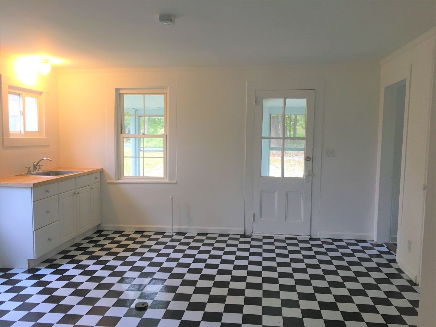  Kitchen  leads to the back enclosed porch and the 1/2 bath is off the kitchen