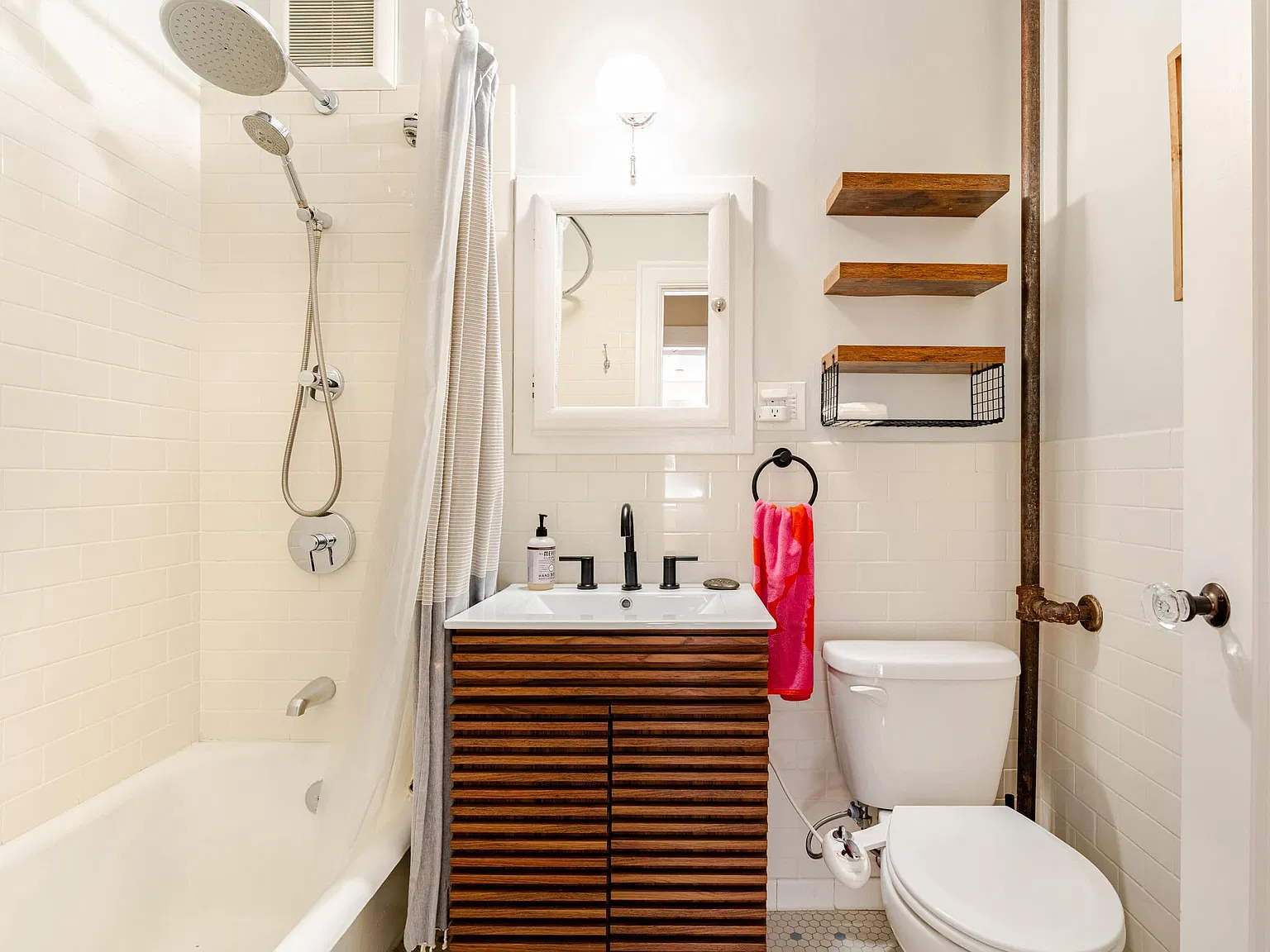 Bathroom: tub and shower with a slatted wood vanity