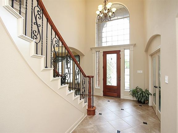 Ornamental arches and granite inlays in the foyer add to the multi-dimensional feel of the home.
