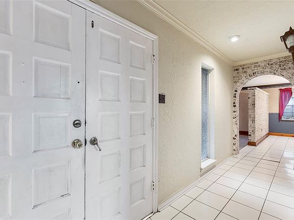 Enter through double doorway into 22' long foyer continuing with the brick archways.